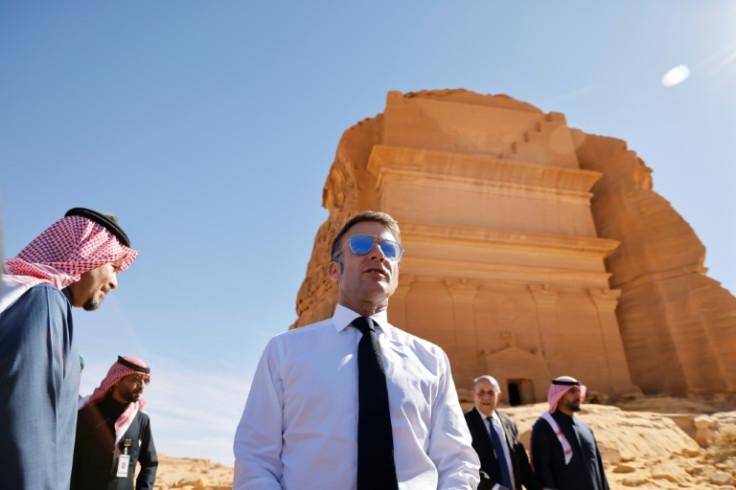 A world away from the crisis, French President Emmanuel Macron strolled through the desert sands of the Al-Ula oasis on a state visit to Saudi Arabia, marvelling at ancient landmarks
