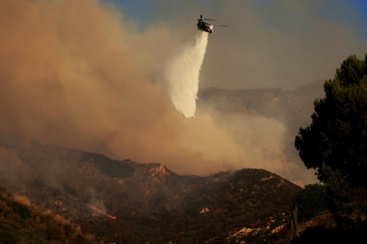 Firefighters are tackling the blaze in Malibu from the air and from the ground