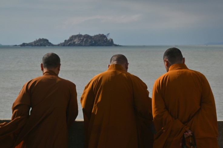 Buddhist monks look over the sea at a temple on Pingtan island, the closest point in China to Taiwan’s main island, in southeast China’s Fujian province on December 11, 2024