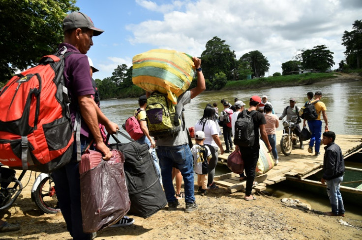 Displaced people from recent clashes between armed groups cross the Tarra River, which divides Colombia and Venezuela, in Tibu, Colombia on January 19, 2025