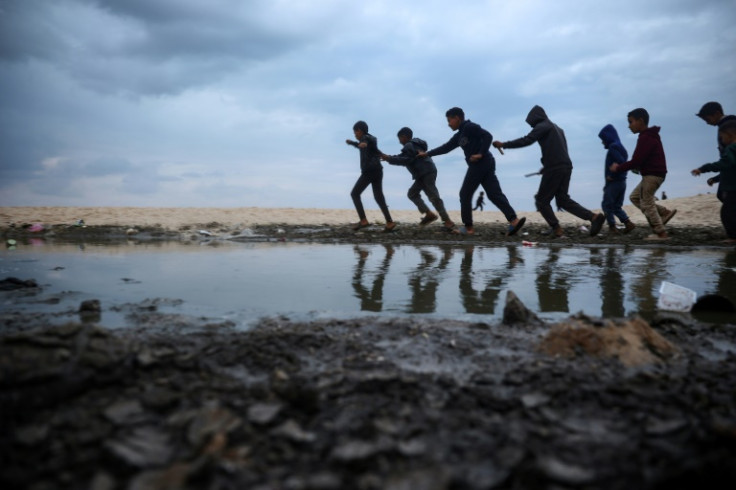Displaced Palestinian children play near tents along a beach in Deir el-Balah on the fourth day of a ceasefire deal in the war between Israel and Hamas
